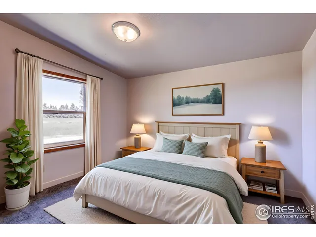 a bedroom with a bed a potted plant and a window