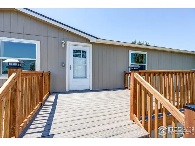 a view of a balcony with wooden floor