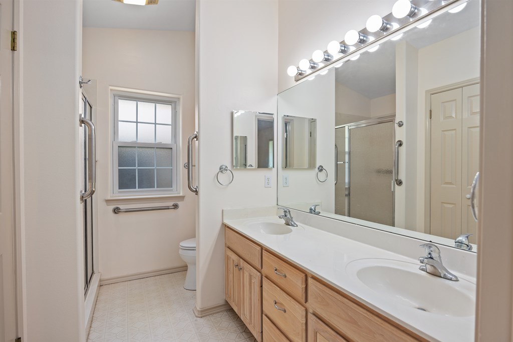 1257 Victory Kerrville, TX 78028 - Photo 13 of 31 a bathroom with a double vanity sink mirror and shower