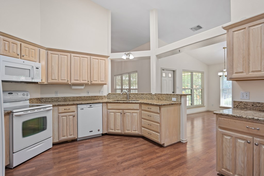 1257 Victory Kerrville, TX 78028 - Photo 2 of 31 a kitchen with granite countertop white cabinets and white appliances