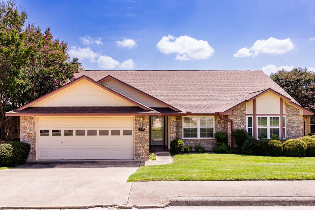 1257 Victory Kerrville, TX 78028 - Photo 28 of 31 a front view of a house with a garden and yard
