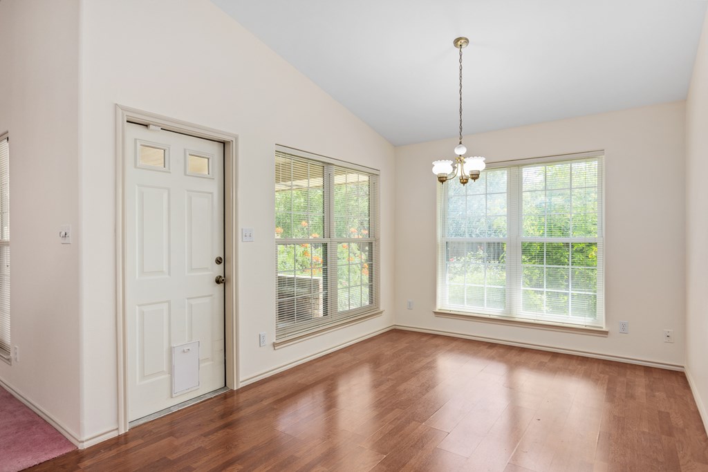 1257 Victory Kerrville, TX 78028 - Photo 3 of 31 a view of an empty room with wooden floor and a window