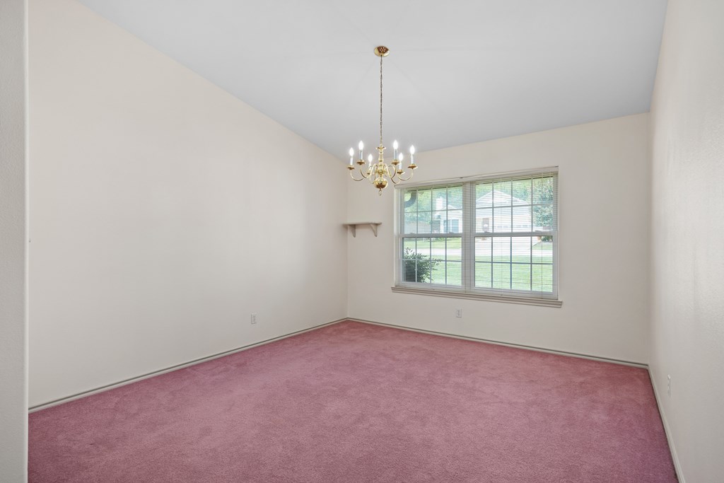 1257 Victory Kerrville, TX 78028 - Photo 7 of 31 an empty room with chandelier fan and windows