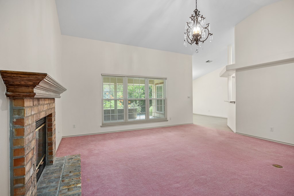 1257 Victory Kerrville, TX 78028 - Photo 8 of 31 a furnished livingroom with a fireplace and a chandelier