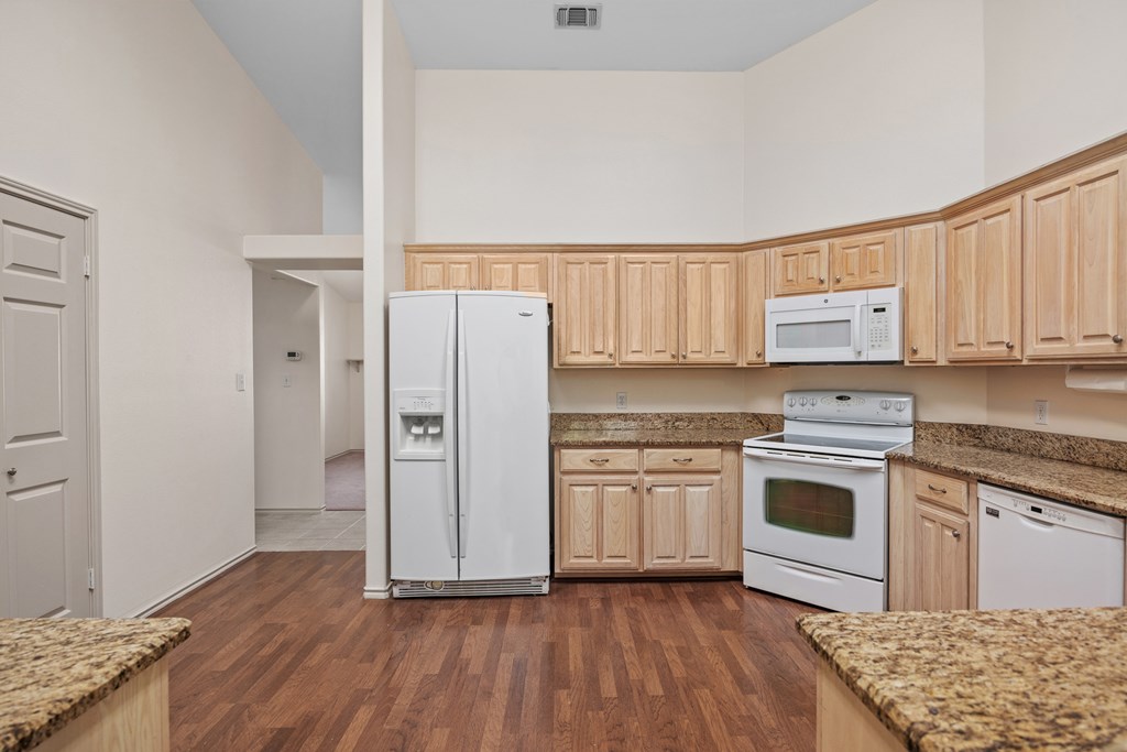 1257 Victory Kerrville, TX 78028 - Photo 10 of 31 a kitchen with granite countertop white cabinets and white appliances