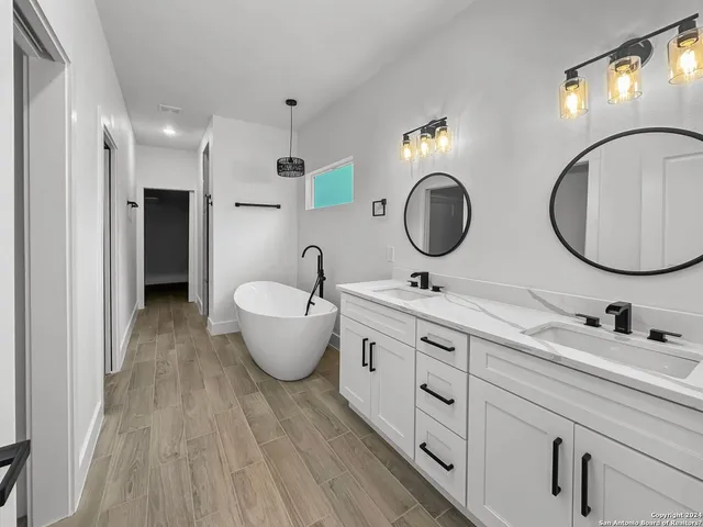 a bathroom with a double vanity sink and a mirror