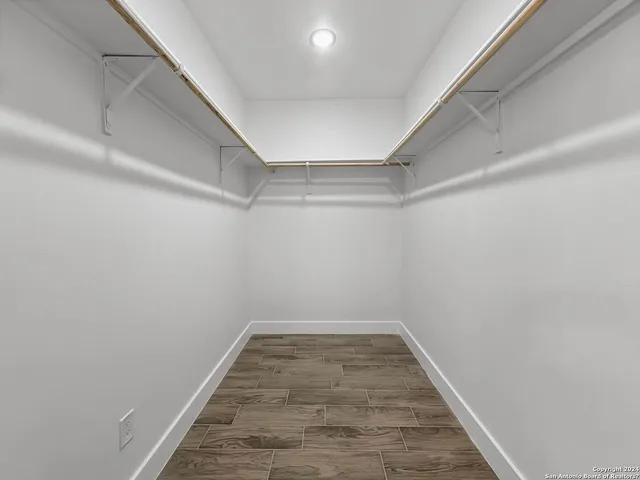 a view of a room with wooden floor