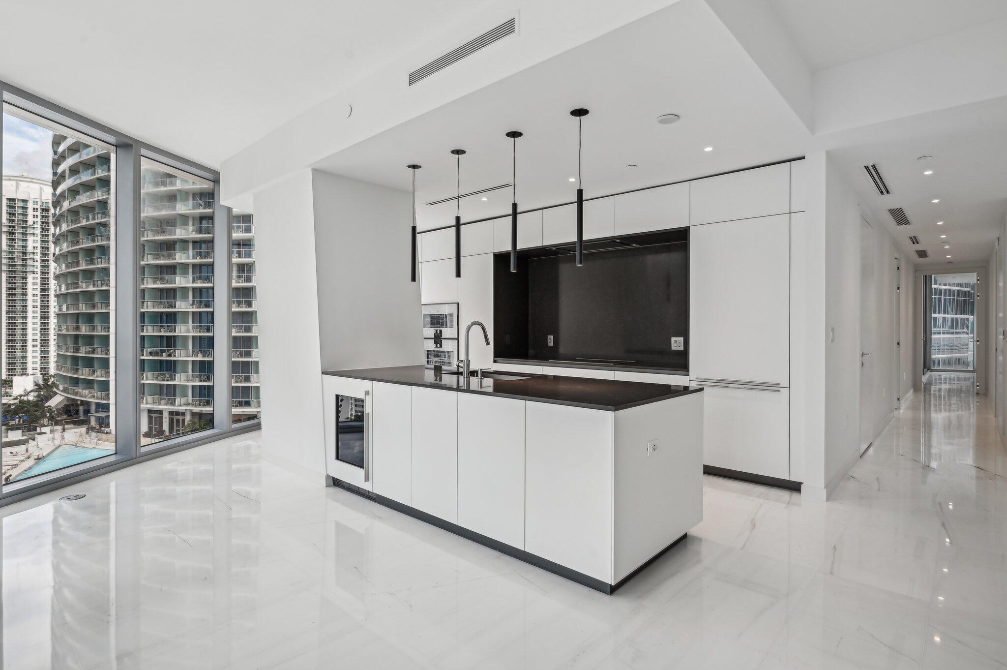 300 Biscayne Blvd Way, Unit 1907 Miami, FL 33131 - Photo 11 of 43 a living room with stainless steel appliances kitchen island granite countertop a stove and a flat screen tv