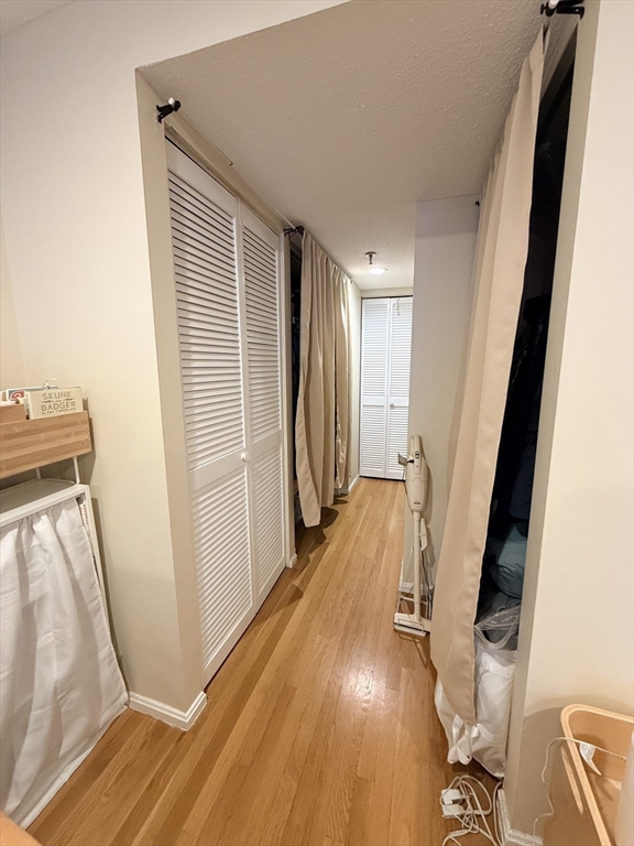 20 Webster Street, Unit 307 Brookline, MA 02446 - Photo 22 of 31 a view of a hallway with wooden floor and stairs