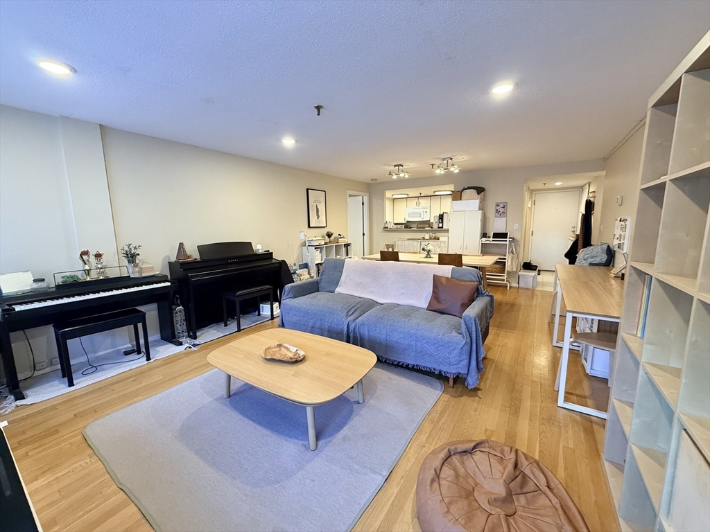 20 Webster Street, Unit 307 Brookline, MA 02446 - Photo 5 of 31 a living room with furniture a rug and a table