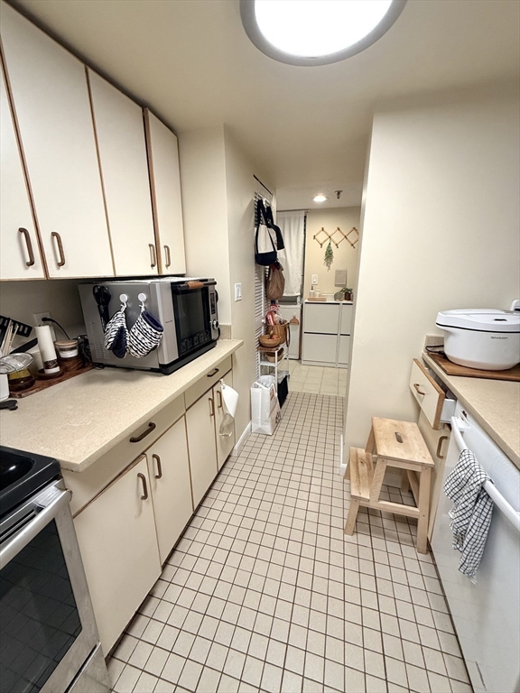 20 Webster Street, Unit 307 Brookline, MA 02446 - Photo 9 of 31 a kitchen with a sink appliances and cabinets