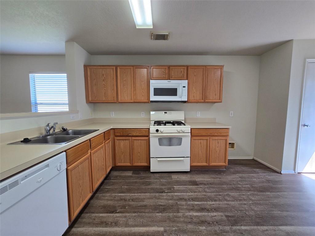 6527 Fairbrook Park Lane Spring, TX 77379 - Photo 7 of 17 a kitchen with a sink stove and microwave