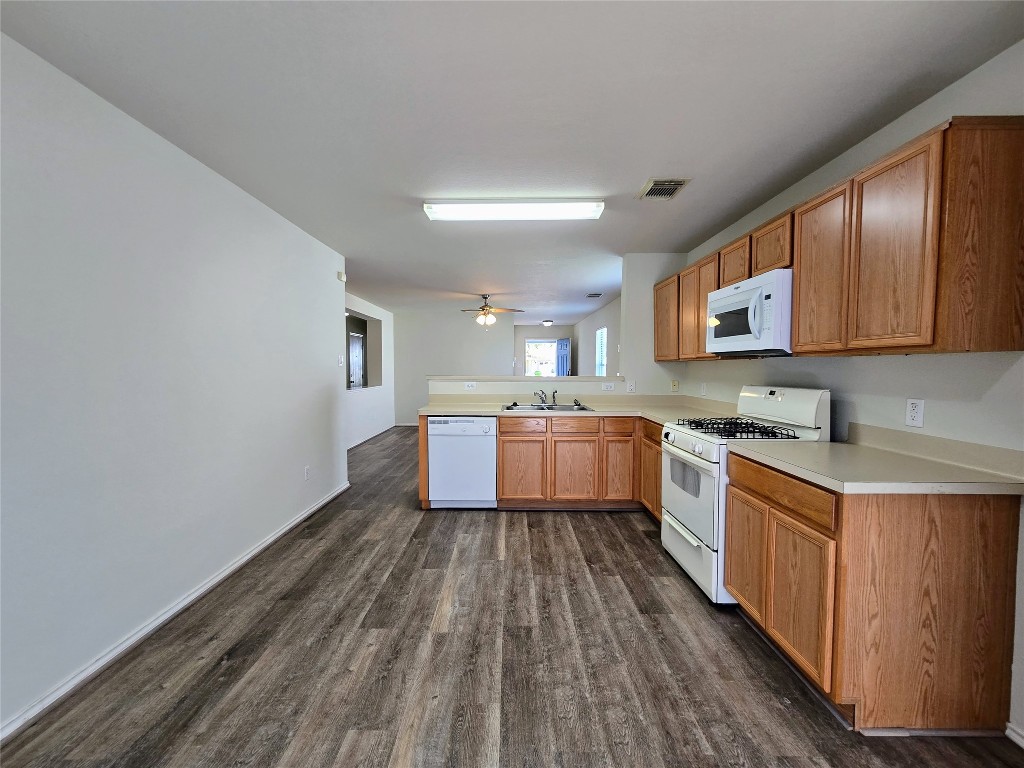 6527 Fairbrook Park Lane Spring, TX 77379 - Photo 8 of 17 a kitchen with stainless steel appliances granite countertop a sink cabinets and wooden floor