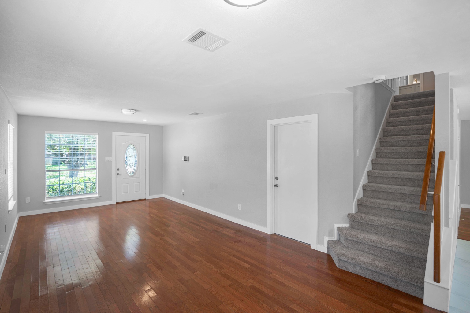 800 Smoke Signal Pass Pflugerville, TX 78660 - Photo 27 of 40 Hardwood floors stretch across the spacious living room, offering a bright and welcoming entry.