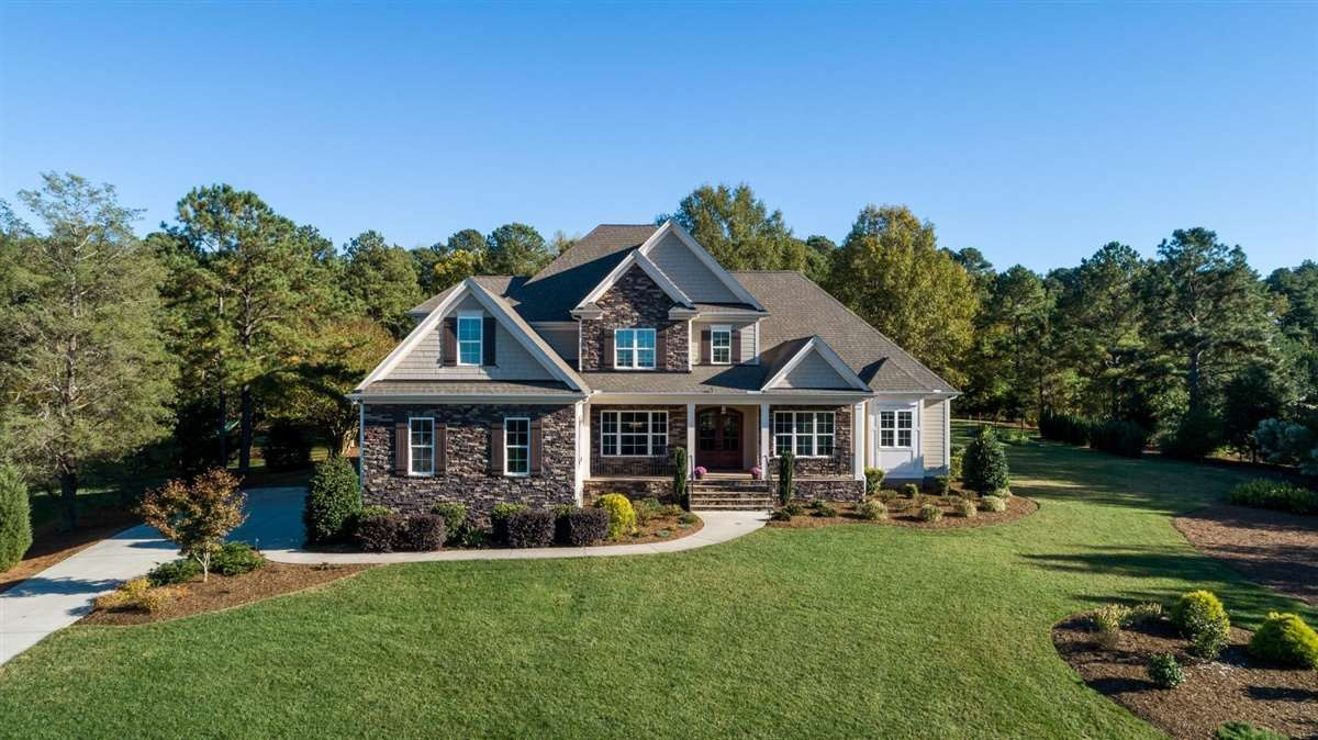 12904 Grovehurst Drive Raleigh, NC 27613 - Photo 1 of 30 Privacy and scenic views abound in this Custom Snyder Hankins home nestled on 1.21 acres abutting to an additional 1.5 acre HOA buffer. Enjoy the rocking chair front porch w/ BI audio & immense flat back yard space, mature trees & gardening beds. Exterior Front