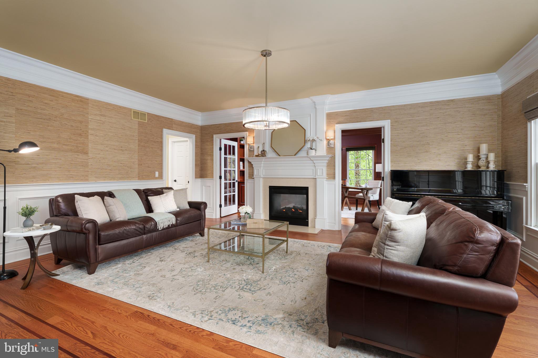 24 Michael Way Pennington, NJ 08534 - Photo 4 of 50 a living room with furniture a fireplace and a large mirror
