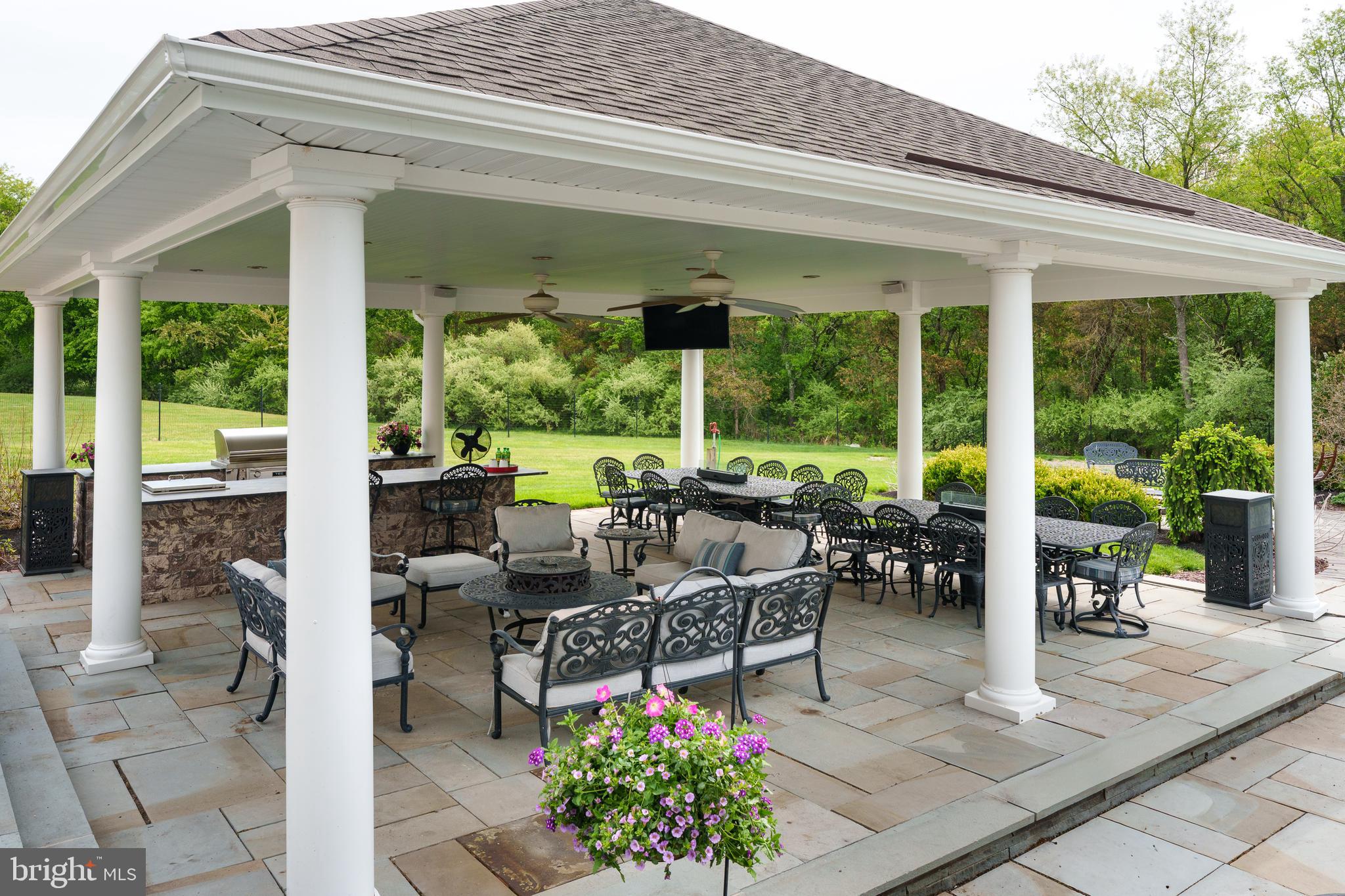 24 Michael Way Pennington, NJ 08534 - Photo 46 of 50 a view of a patio with table and chairs potted plants and floor to ceiling window
