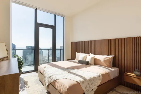 a bedroom with a bed and a large window