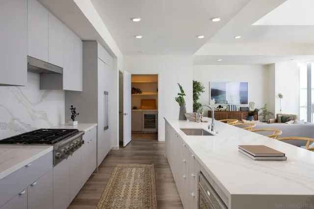 a living room with furniture and large windows
