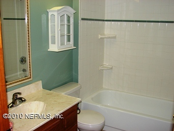 2136 Rothbury Drive Jacksonville, FL 32221 - Photo 11 of 18 a bathroom with a granite countertop sink toilet and shower