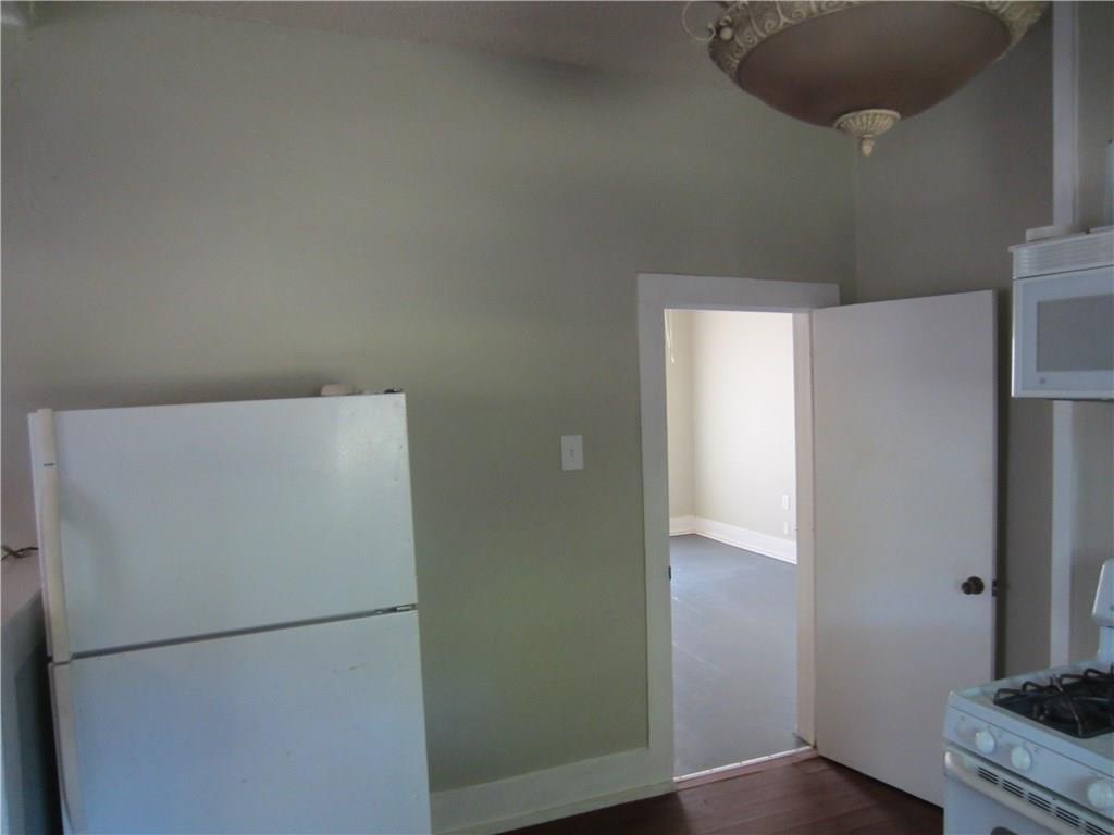 1102 Peak Street Denton, TX 76201 - Photo 4 of 11 a white refrigerator freezer sitting inside of a kitchen