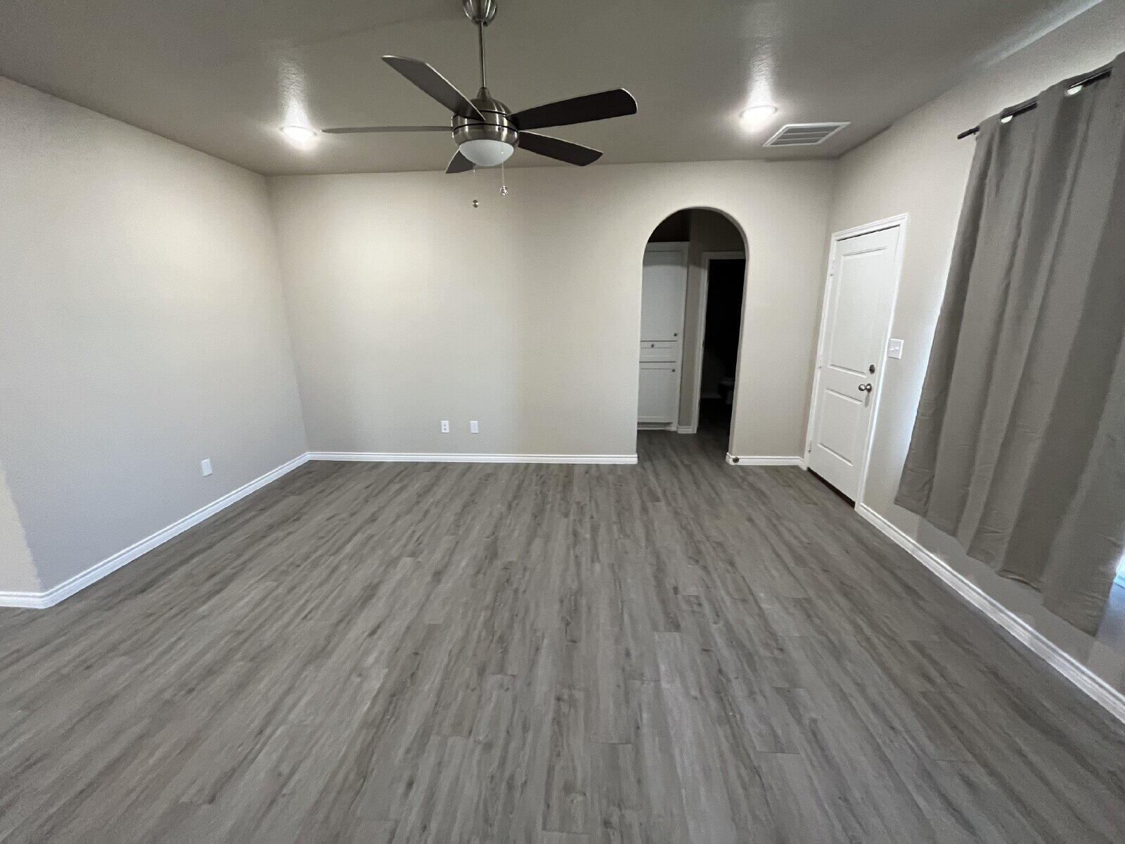 7010 12th Street Lubbock, TX 79416 - Photo 2 of 13 wooden floor in an empty room with a window