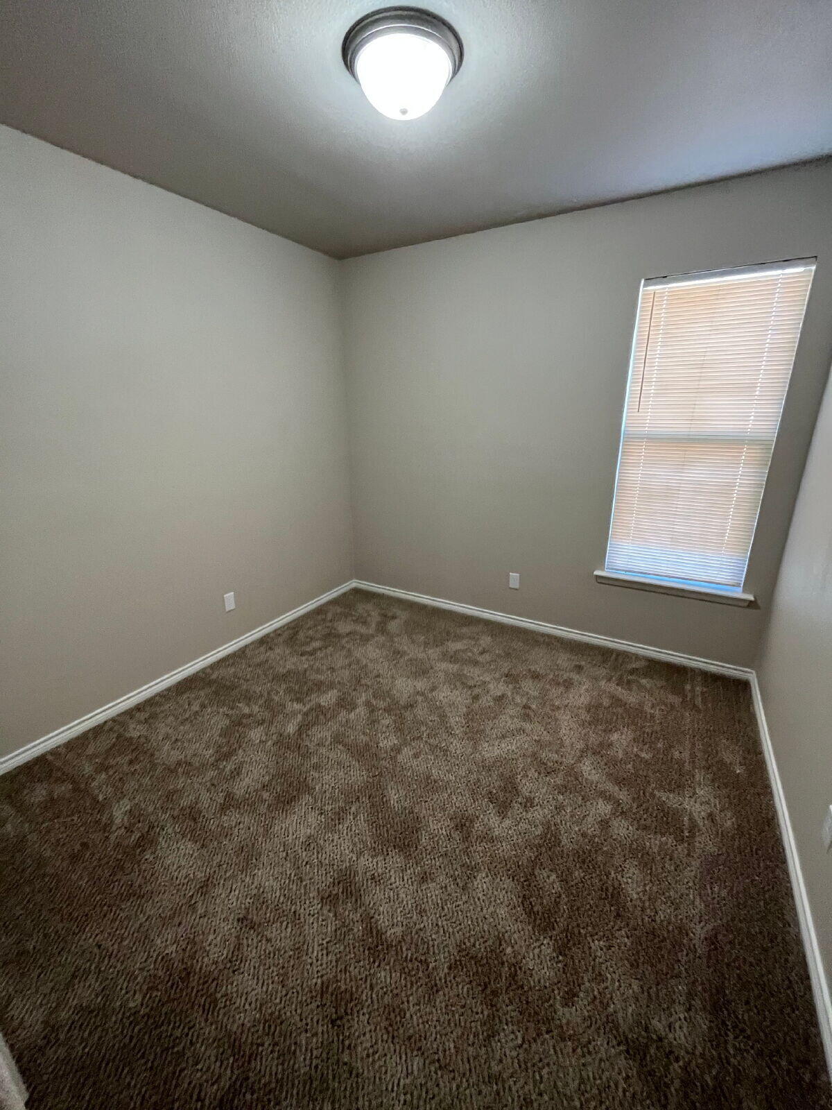 7010 12th Street Lubbock, TX 79416 - Photo 9 of 13 an empty room with a window