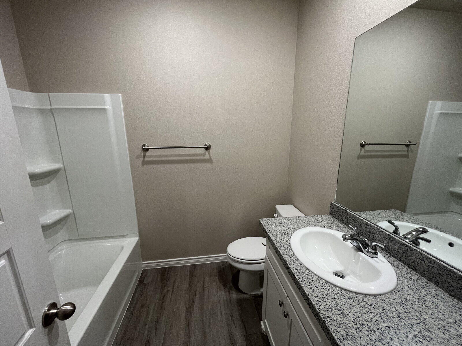7010 12th Street Lubbock, TX 79416 - Photo 10 of 13 a bathroom with a granite countertop sink toilet and shower