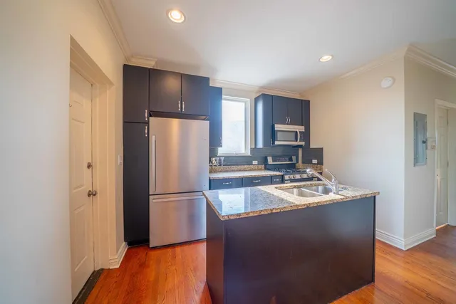 a kitchen with a refrigerator and a sink