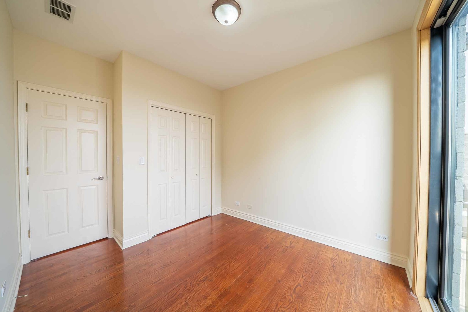 3123 West Washington Boulevard, Unit 3 Chicago, IL 60612 - Photo 15 of 24 an empty room with wooden floor and windows