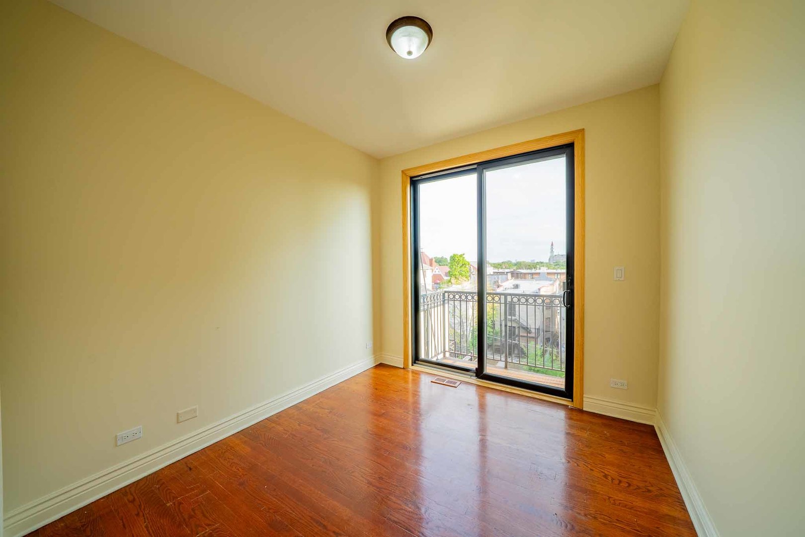 3123 West Washington Boulevard, Unit 3 Chicago, IL 60612 - Photo 17 of 24 a view of an empty room with wooden floor and a window