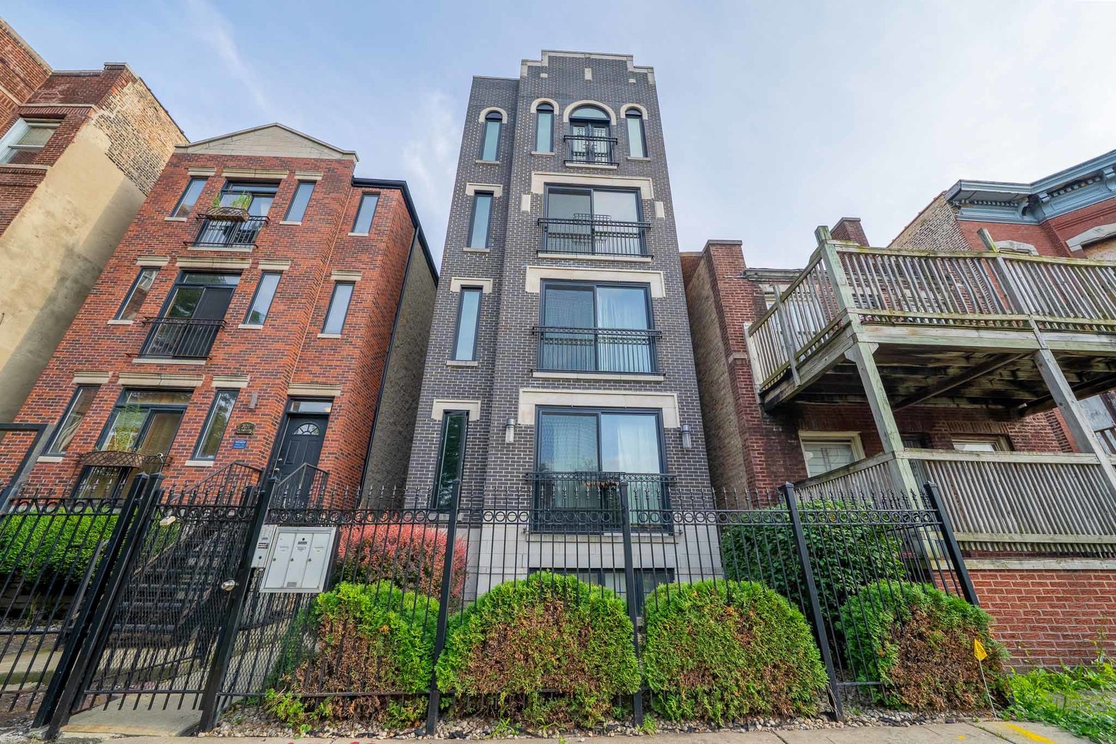 3123 West Washington Boulevard, Unit 3 Chicago, IL 60612 - Photo 2 of 24 a front view of a residential apartment building with a yard