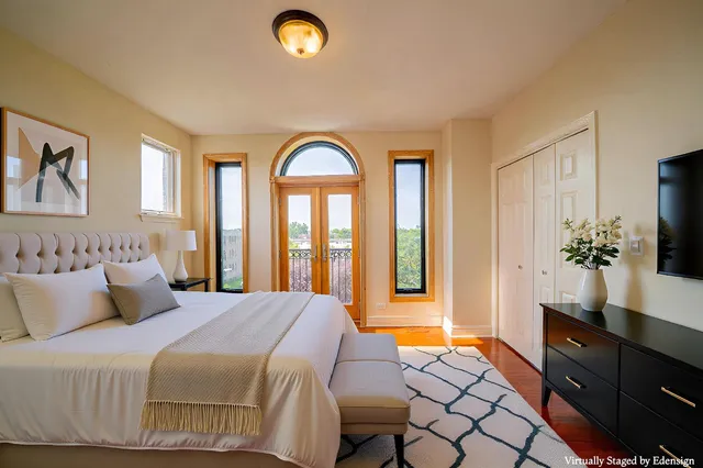 a bedroom with a bed and a flat screen tv