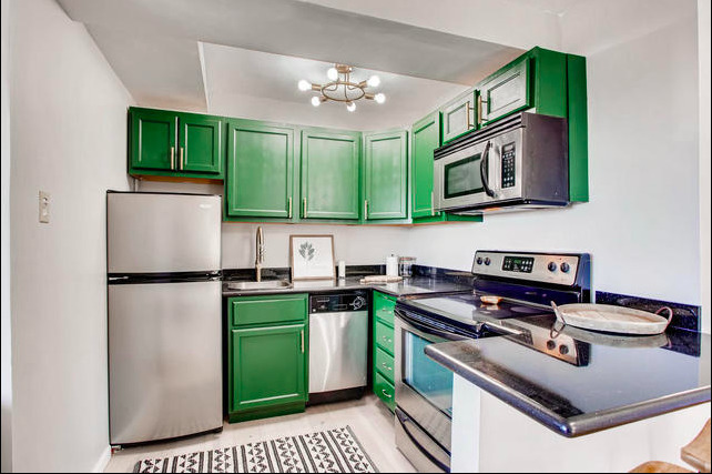 2909 North Sheridan Road, Unit 1810 Chicago, IL 60657 - Photo 2 of 9 a kitchen with cabinets a stove top oven and sink