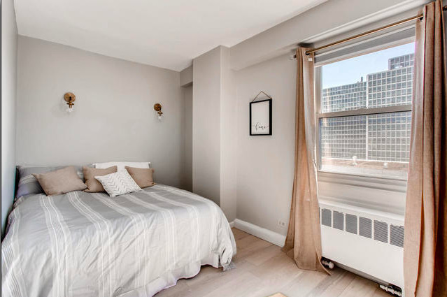 2909 North Sheridan Road, Unit 1810 Chicago, IL 60657 - Photo 4 of 9 a bedroom with a bed and a window