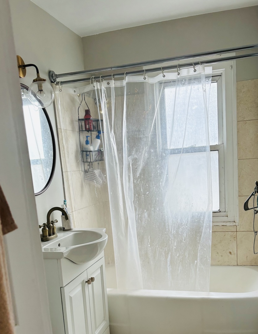 2909 North Sheridan Road, Unit 1810 Chicago, IL 60657 - Photo 6 of 9 a bathroom with a sink and a shower