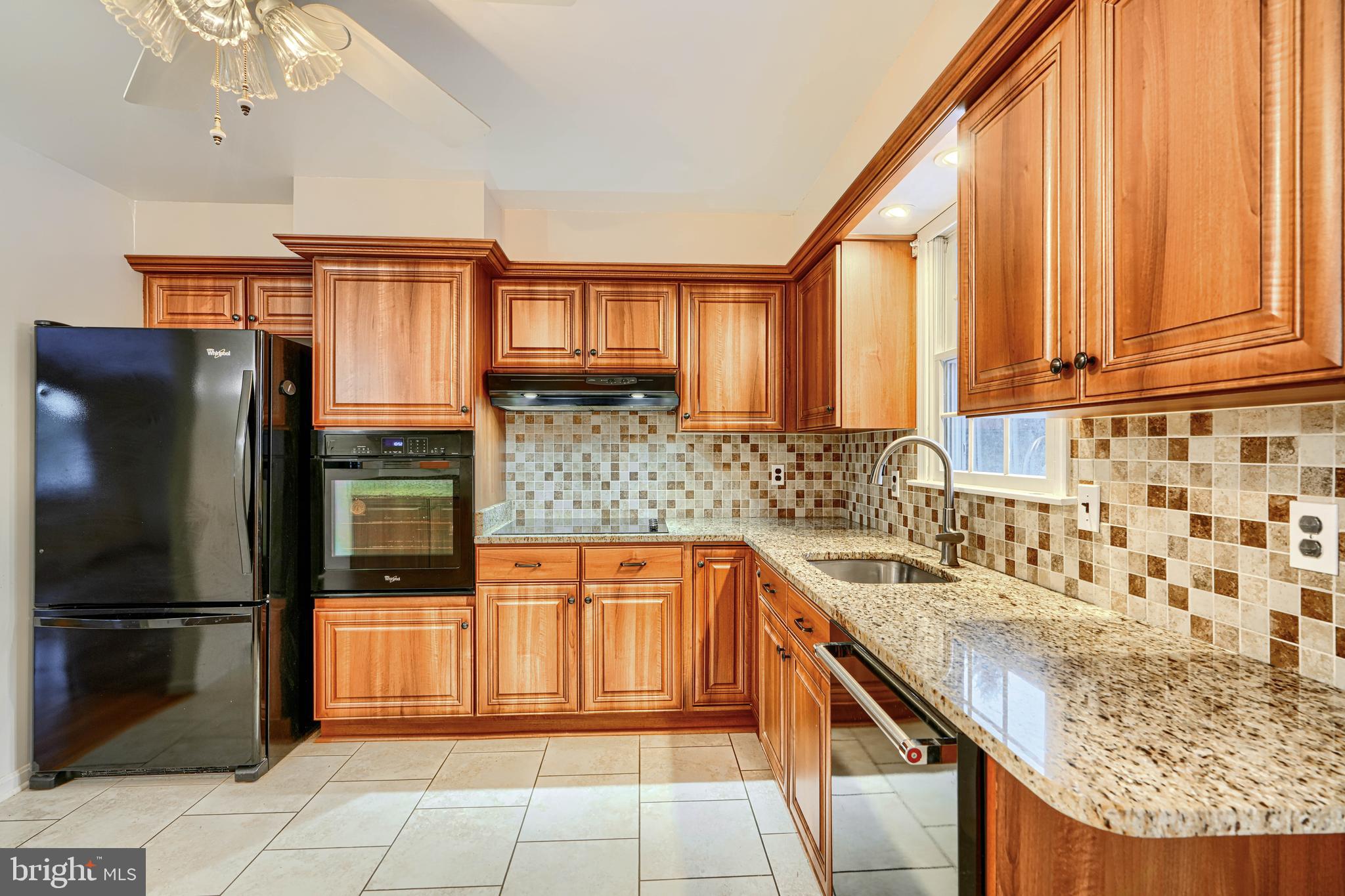 3528 Stansbury Mill Road Phoenix, MD 21131 - Photo 11 of 48 a kitchen with stainless steel appliances granite countertop a sink and a refrigerator