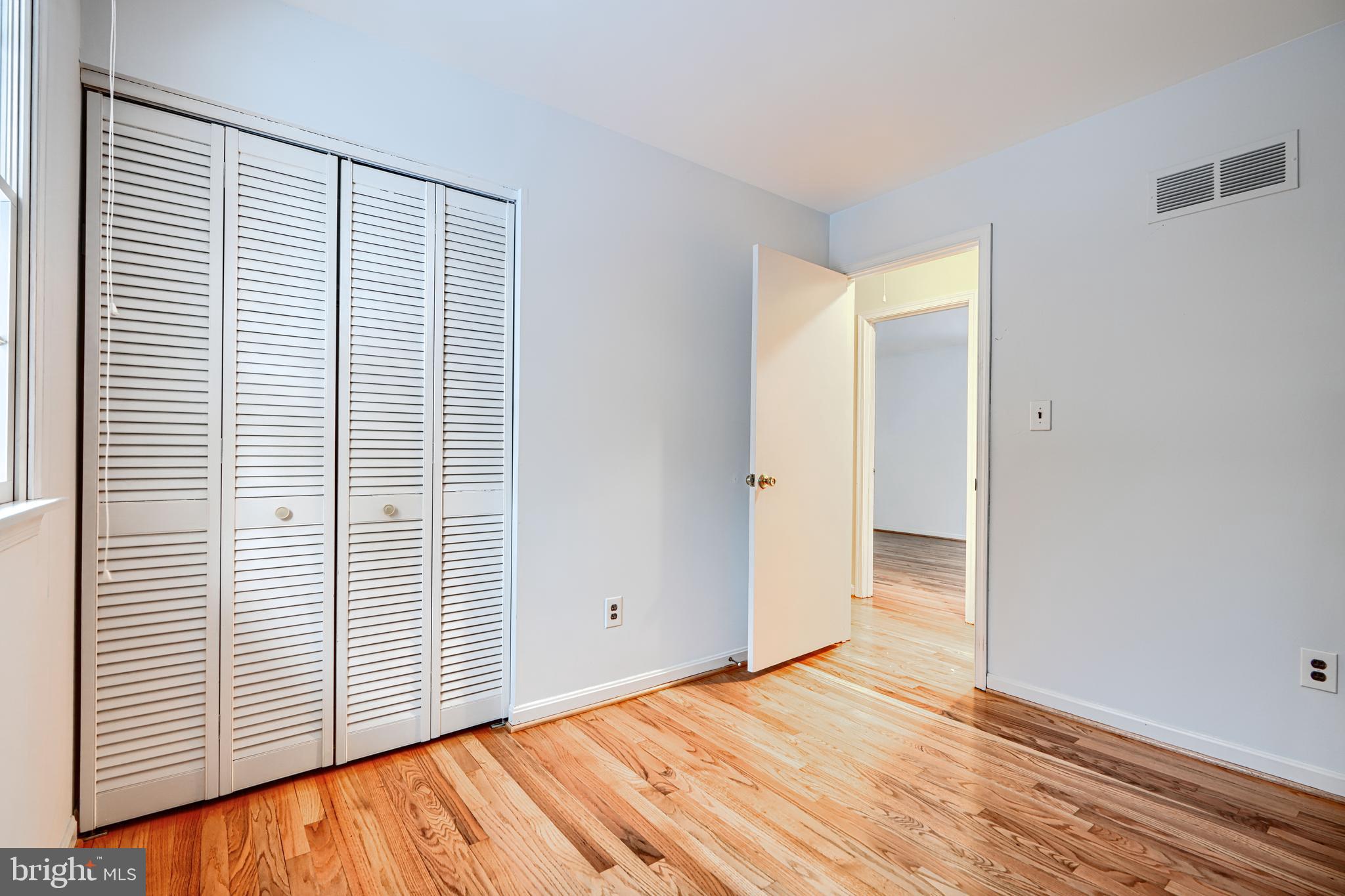3528 Stansbury Mill Road Phoenix, MD 21131 - Photo 17 of 48 a view of an empty room with wooden floor and a window