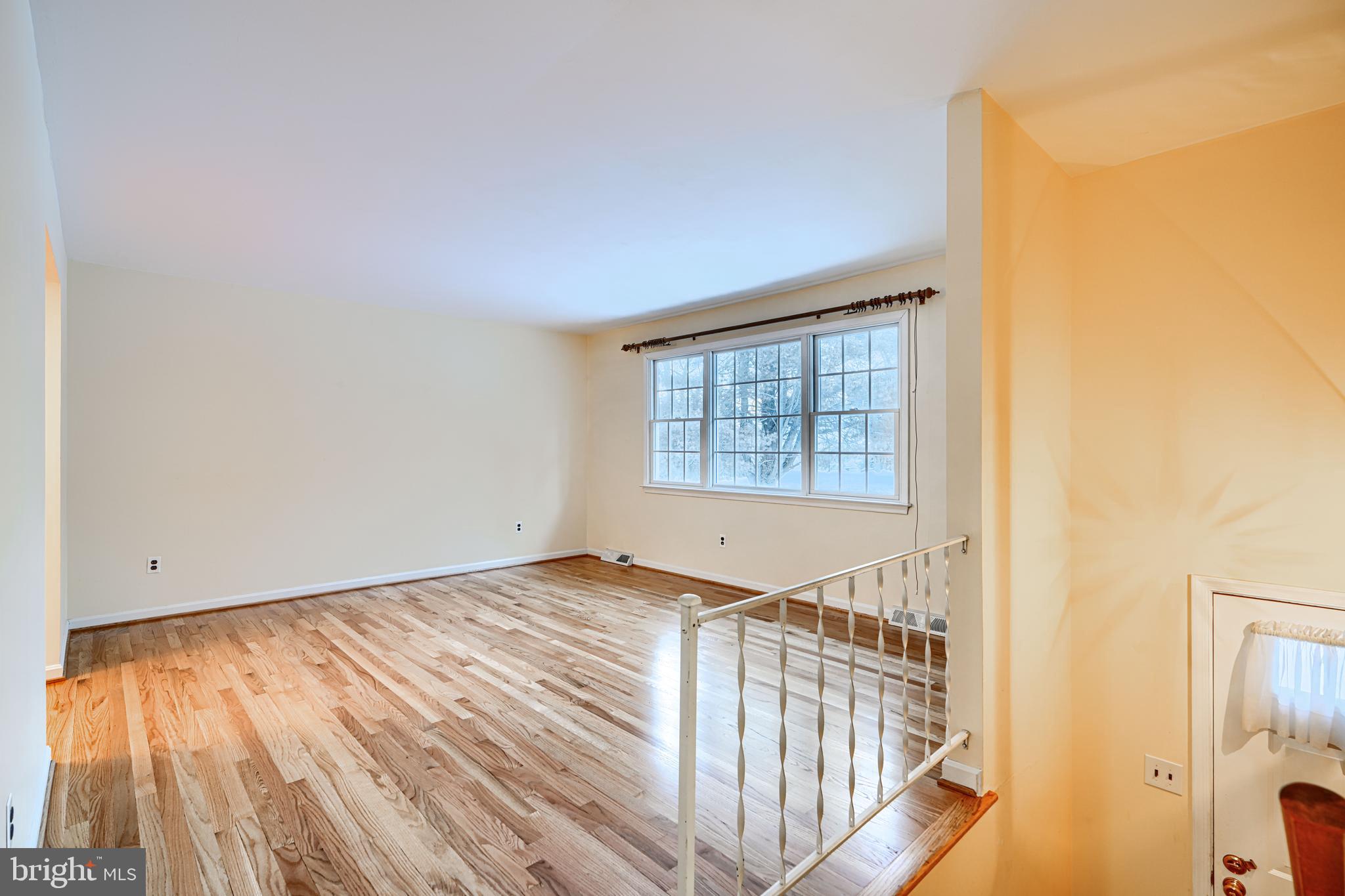 3528 Stansbury Mill Road Phoenix, MD 21131 - Photo 4 of 48 a view of an empty room with wooden floor and a window