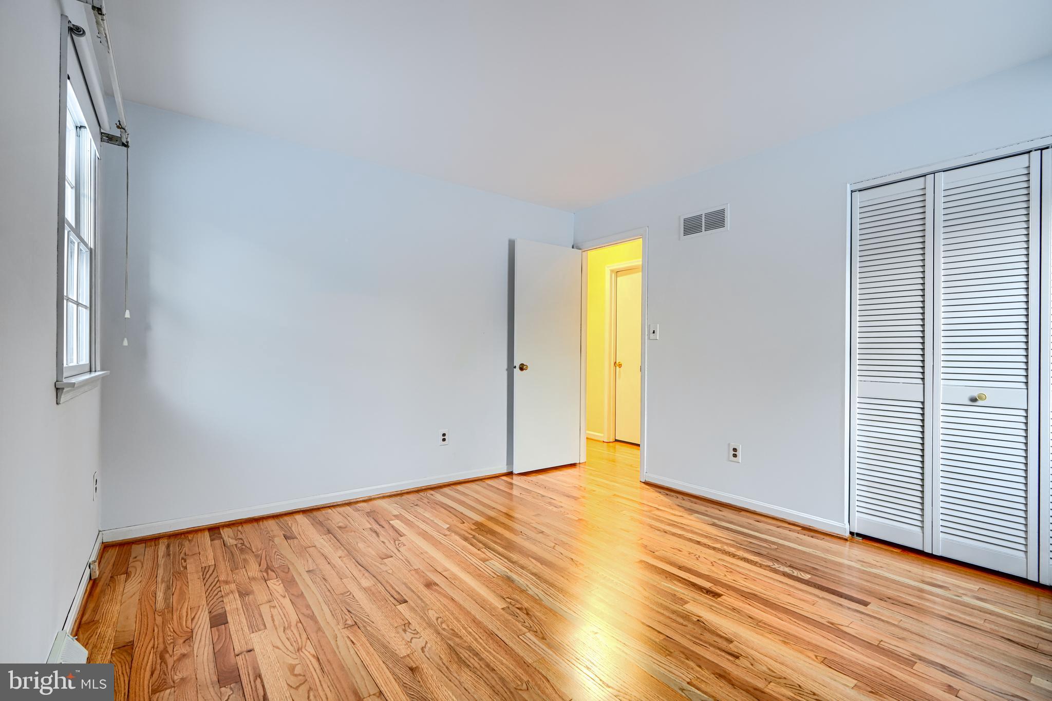 3528 Stansbury Mill Road Phoenix, MD 21131 - Photo 48 of 48 a view of empty room with wooden floor and bathroom view