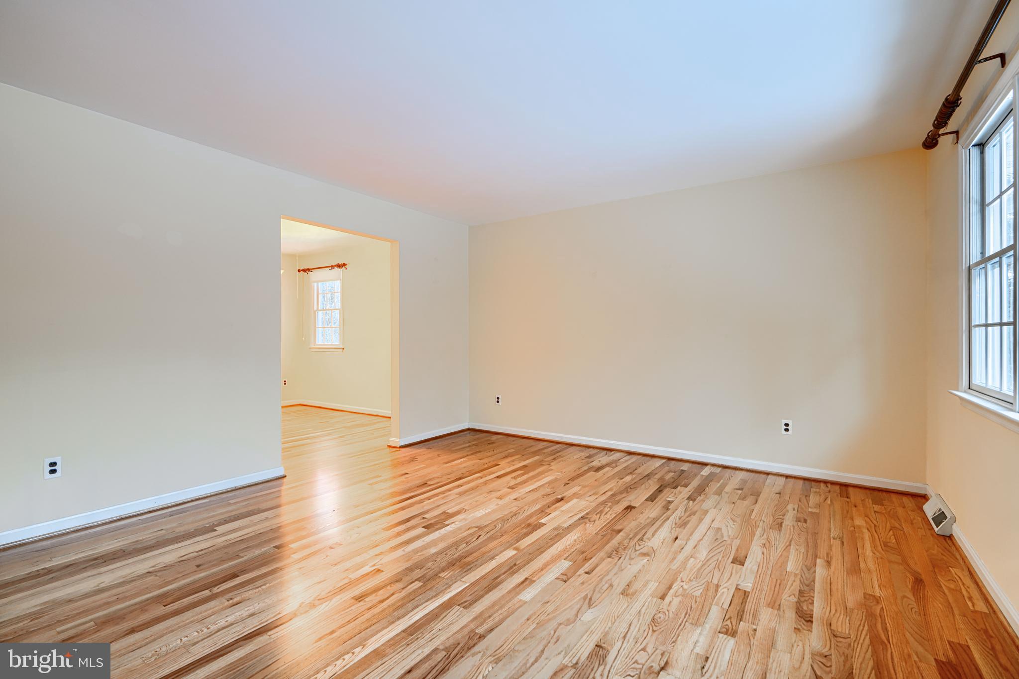 3528 Stansbury Mill Road Phoenix, MD 21131 - Photo 6 of 48 an empty room with wooden floor and windows