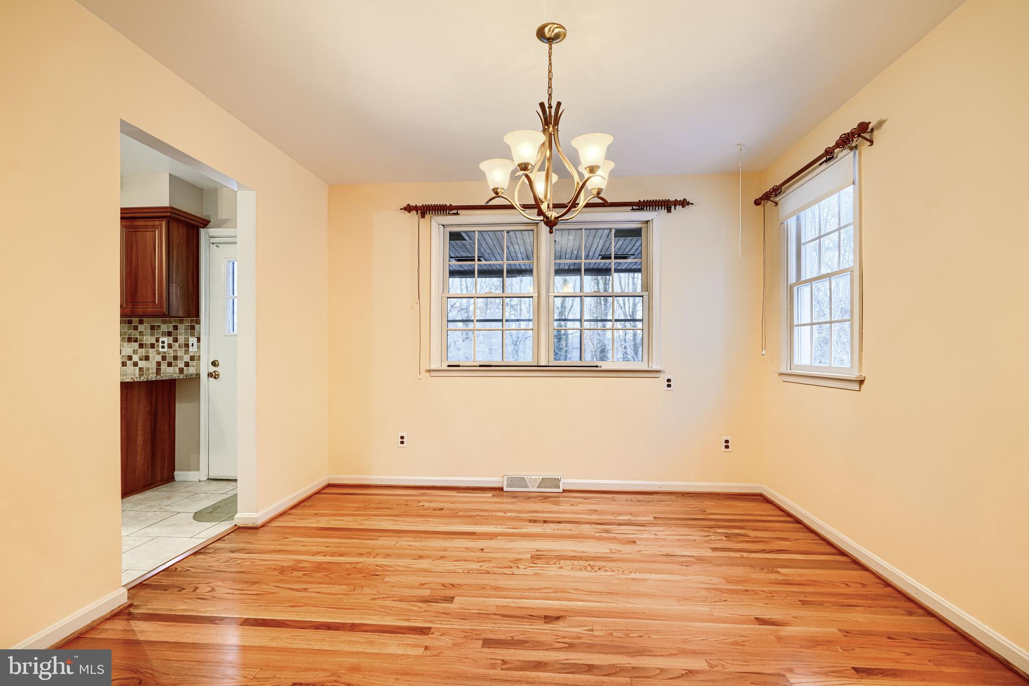 3528 Stansbury Mill Road Phoenix, MD 21131 - Photo 8 of 48 a view of empty room with wooden floor and windows