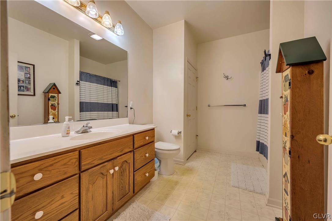 2715 Maple Drive Hellertown, PA 18055 - Photo 14 of 47 a spacious bathroom with a double vanity sink toilet mirror and shower