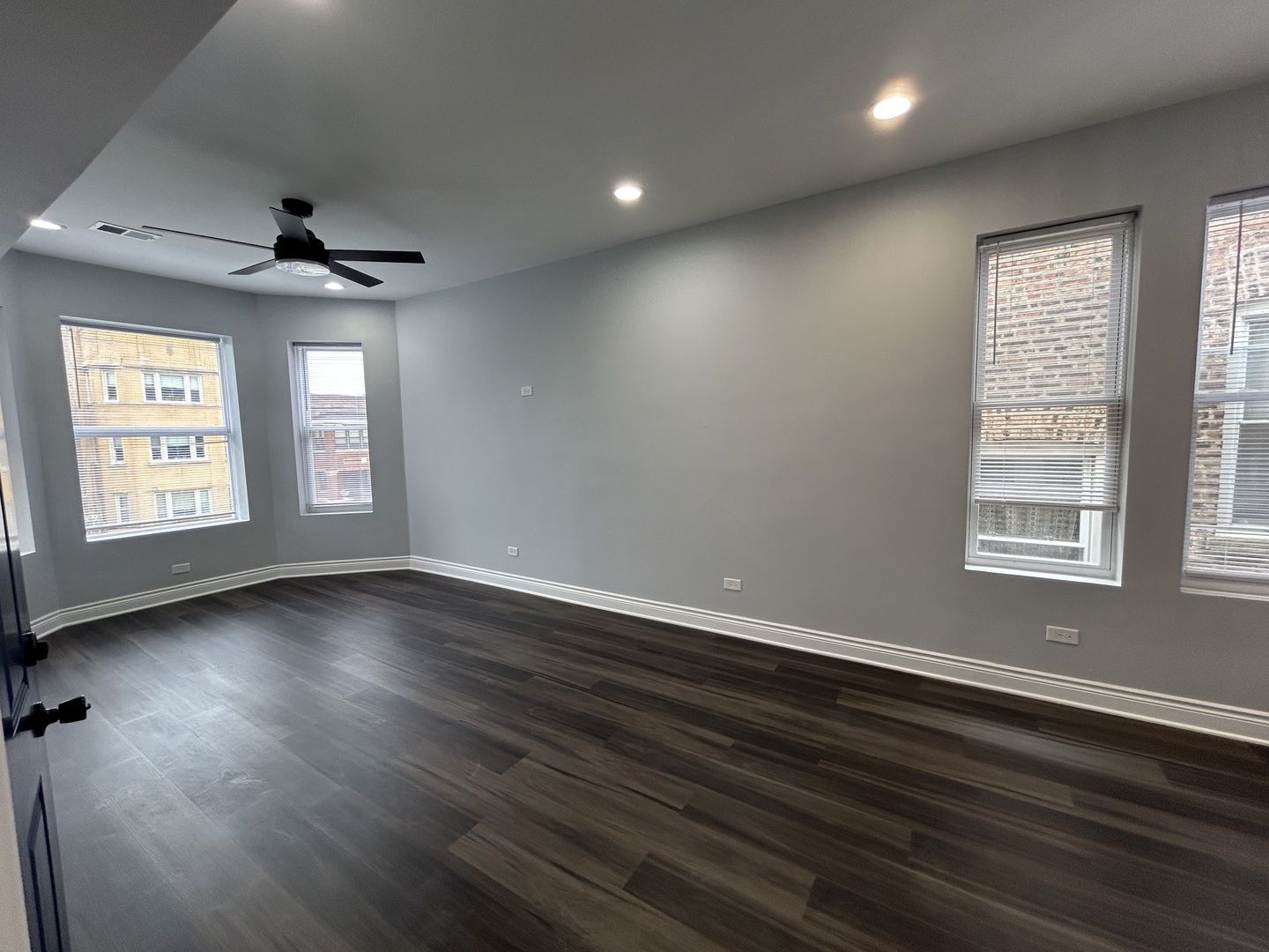 7940 South Carpenter Street, Unit 2 Chicago, IL 60620 - Photo 13 of 34 an empty room with wooden floor chandelier and windows