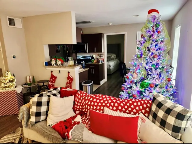 a living room with furniture and wooden floor