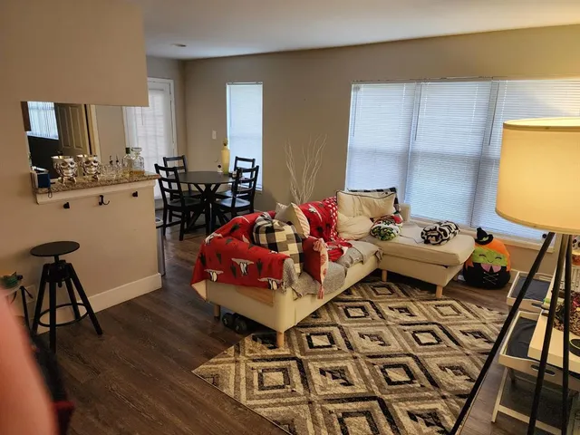 a living room with furniture and flowers