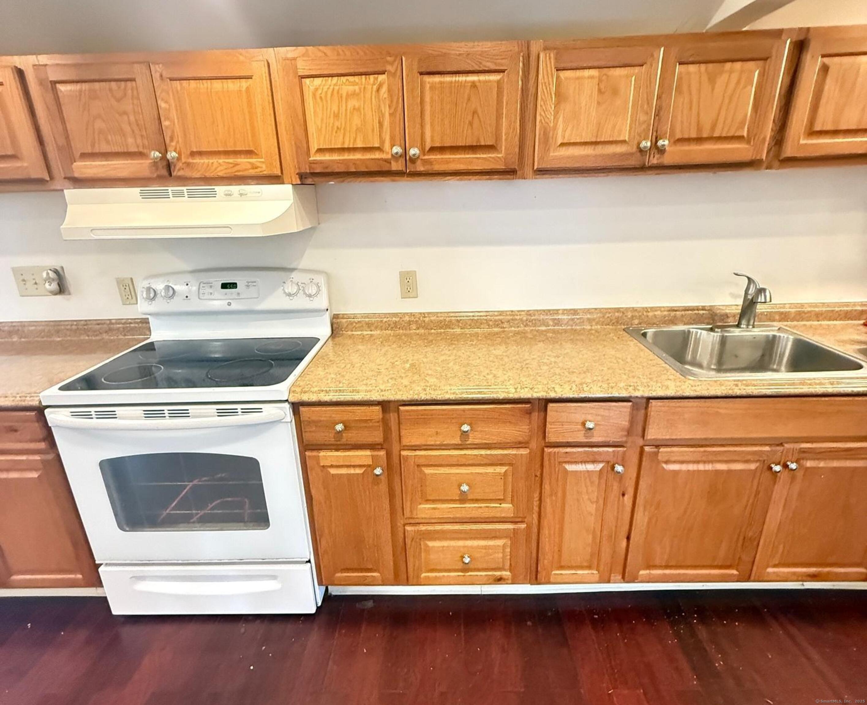 23 Hayward Avenue, Unit 5 Colchester, CT 06415 - Photo 3 of 20 a kitchen with granite countertop a sink a stove and cabinets