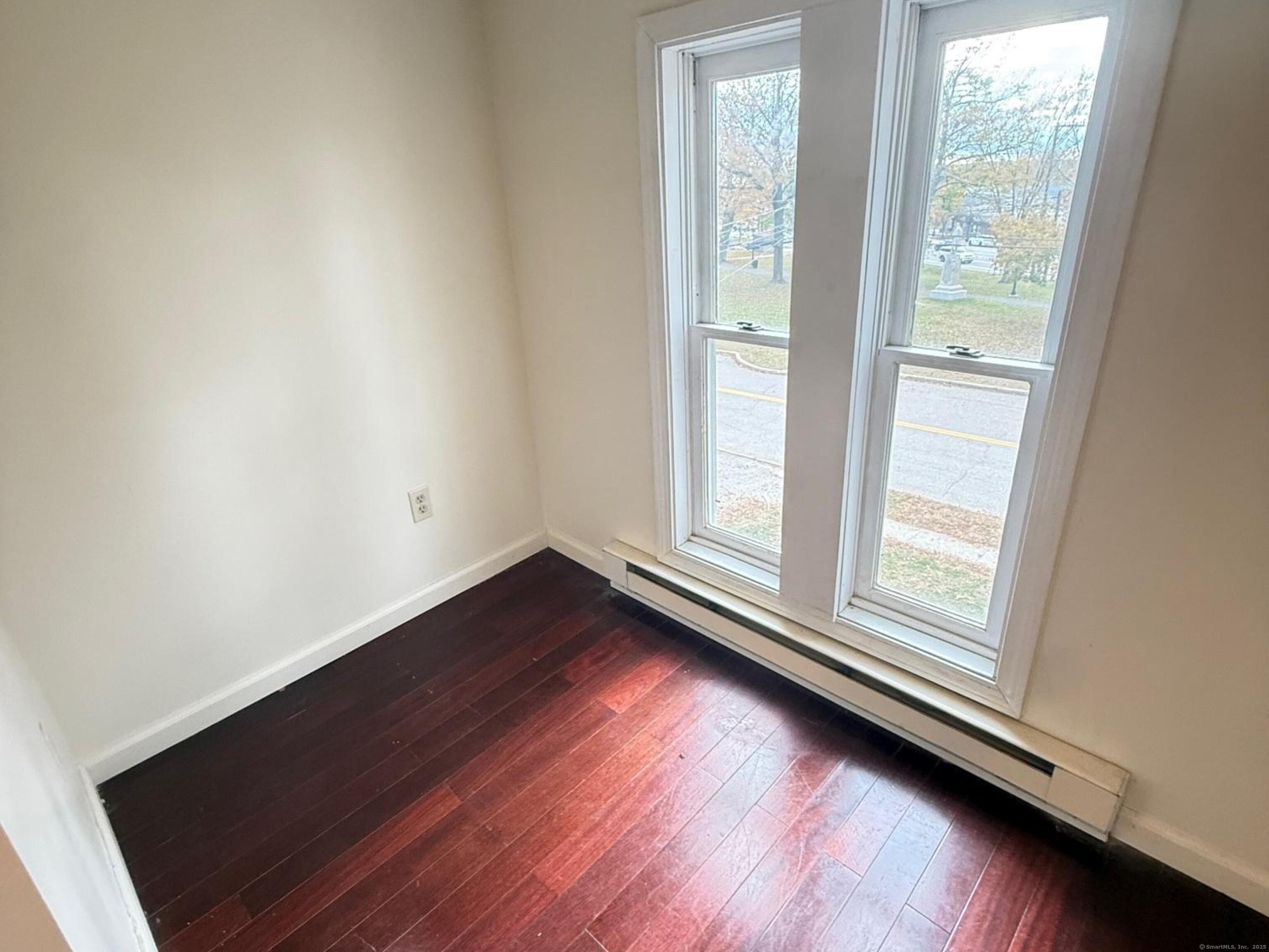23 Hayward Avenue, Unit 5 Colchester, CT 06415 - Photo 5 of 20 an empty room with wooden floor and windows