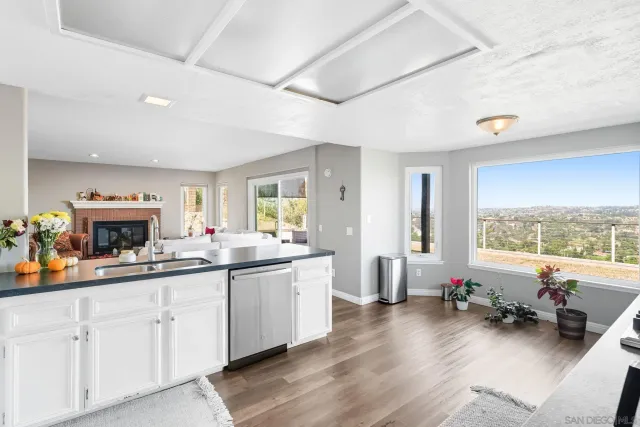a kitchen with sink stove and cabinets