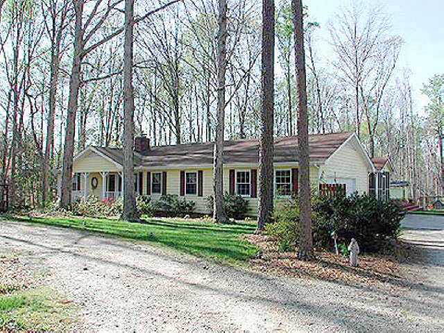 2005 Valley Ridge Court Raleigh, NC 27603 - Photo 1 of 1 a front view of a house with a garden and trees